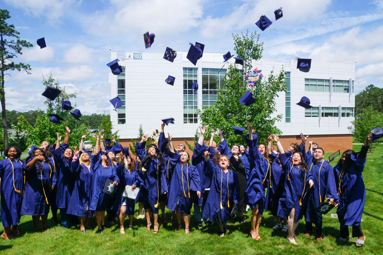 graduates throwing caps in air